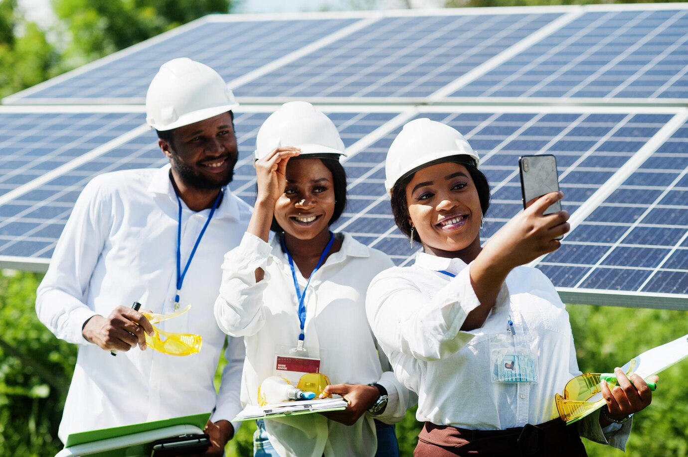 african-american-technician-checks-maintenance-solar-panels-group-three-black-engineers-meeting-solar-station-make-selfie-by-phone_627829-4852